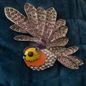 Rara Avis (Disney CN)  created by Iris Apfel vintage sparrow brooch.